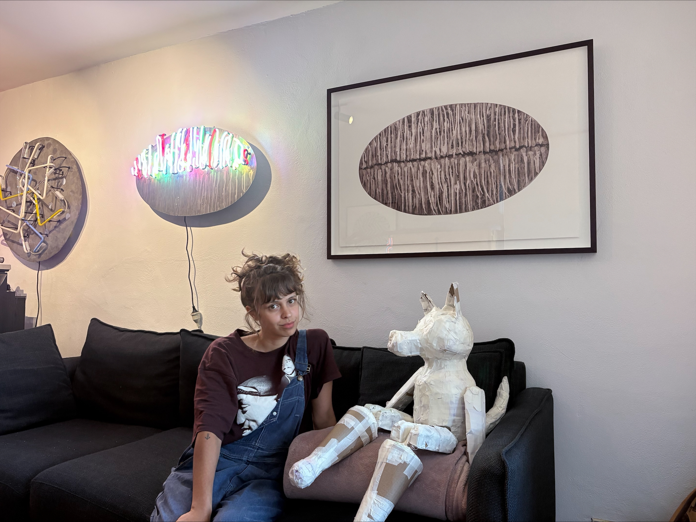 Lily Wilson sitting near some of her artworks.